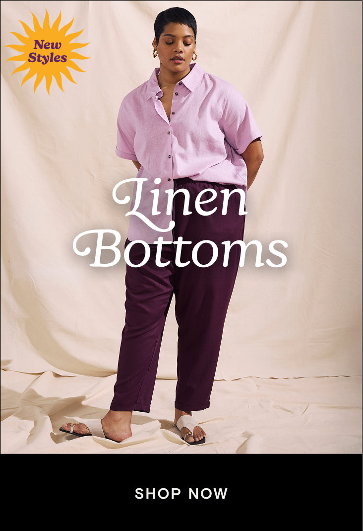 woman wearing lilac linen button down top with acai colored linen pants and a cta that links to the linen bottoms