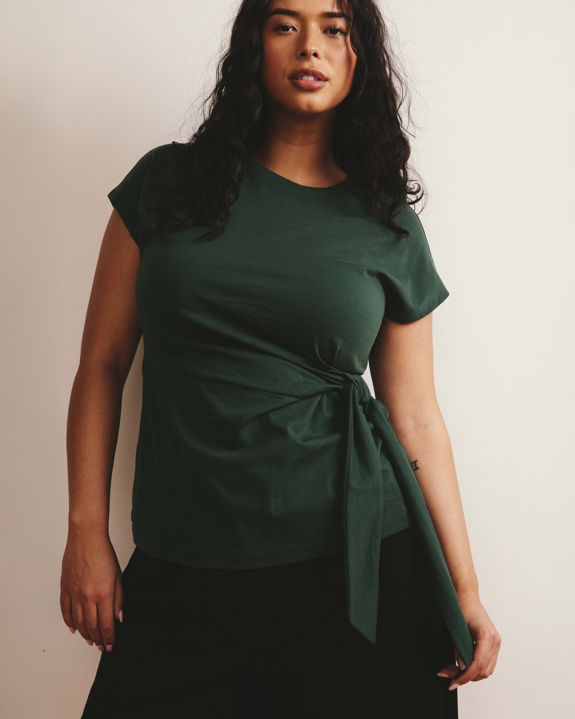 Woman wearing Crescent Breton Stripe Knot Tee - Solid Conifer from Universal Standard