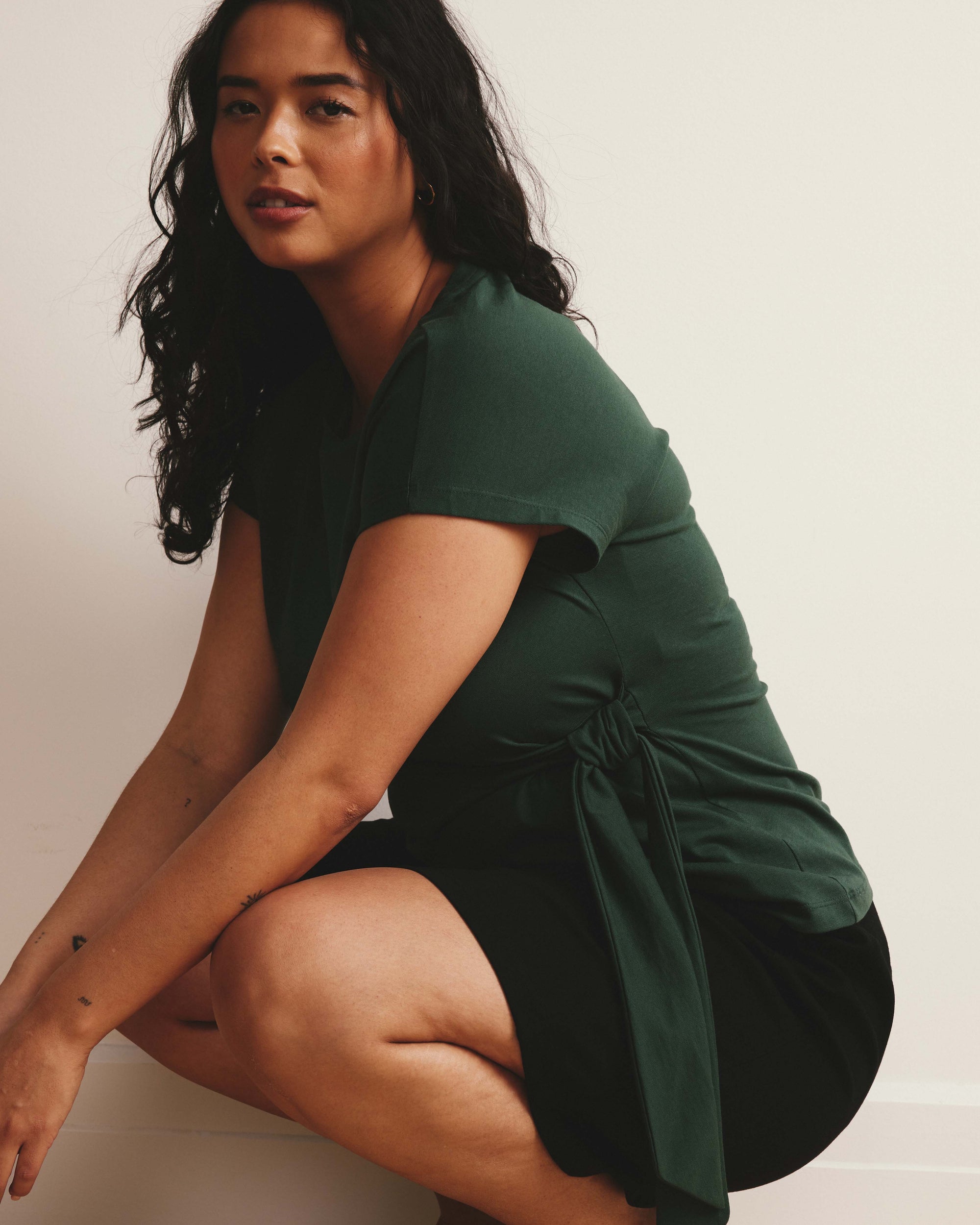 Woman wearing Crescent Breton Stripe Knot Tee - Solid Conifer from Universal Standard