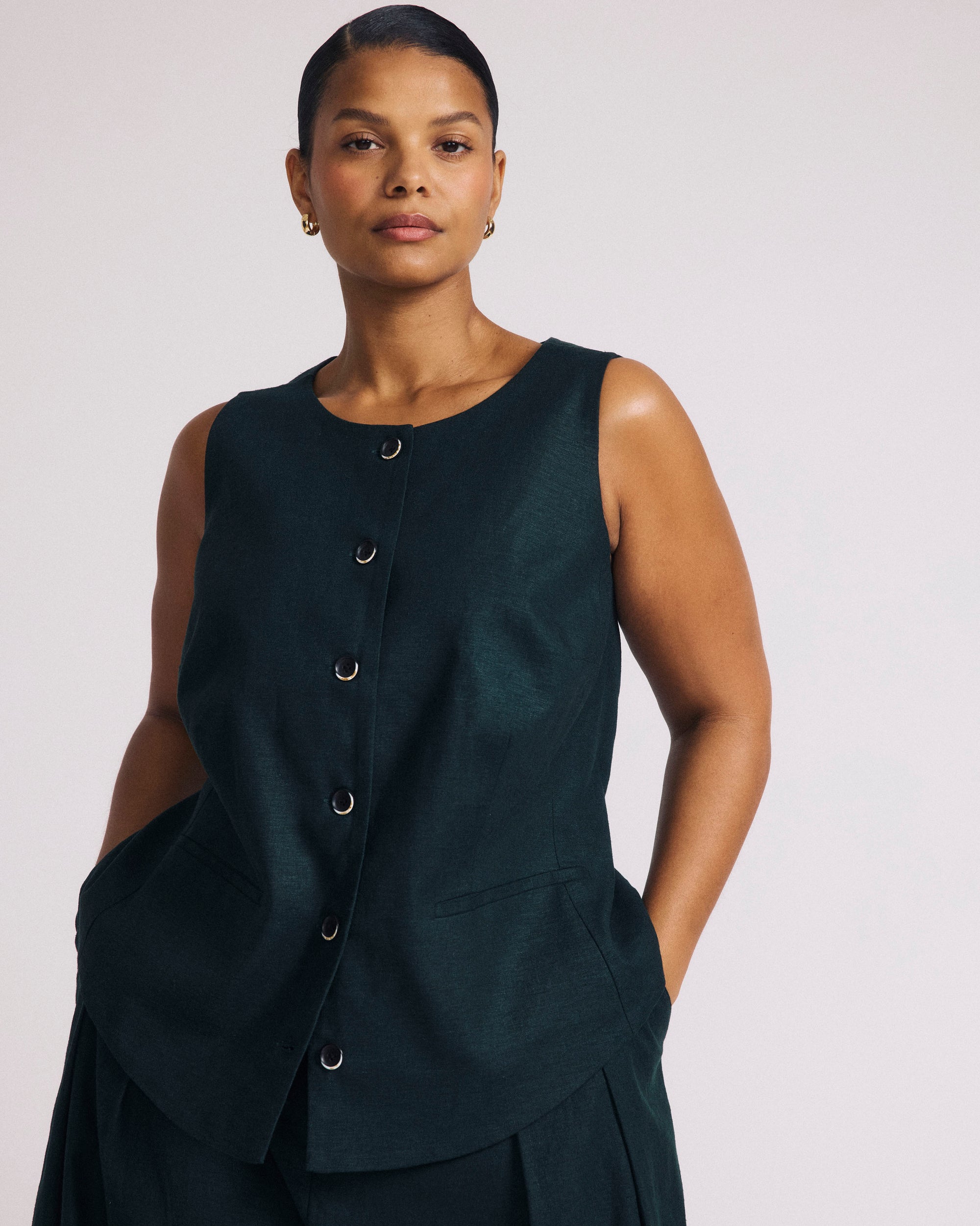 Woman wearing Tamsin Stretch Linen Vest - Forest Green from Universal Standard