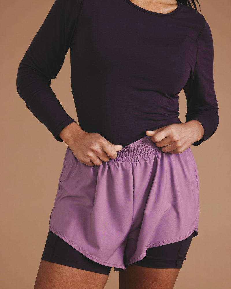 Woman wearing Rebel Active Shorts - Purple/Purple Jewel from Universal Standard