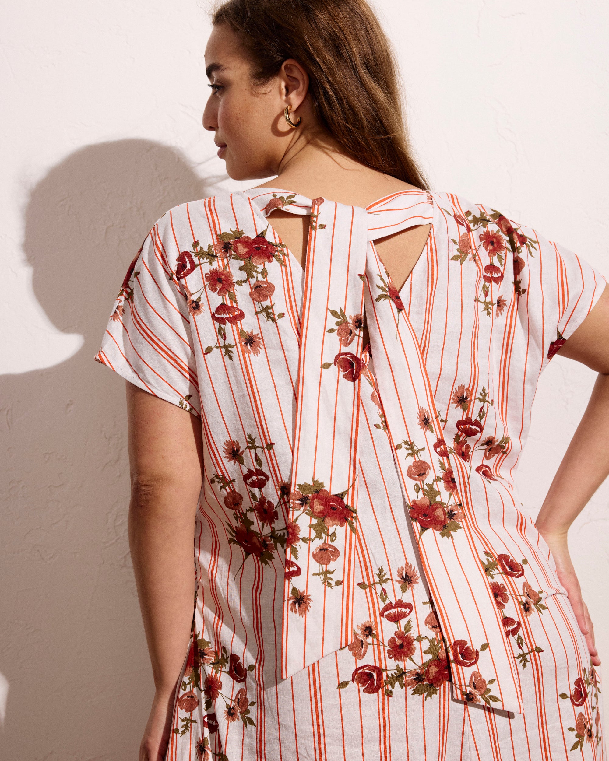Woman wearing Louvre Bow Back Linen Dress - Wild Flower Bouquet Print on Stripes from Universal Standard