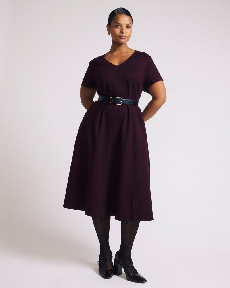 Woman wearing Lucinda Ponte Dress - Black Cherry from Universal Standard