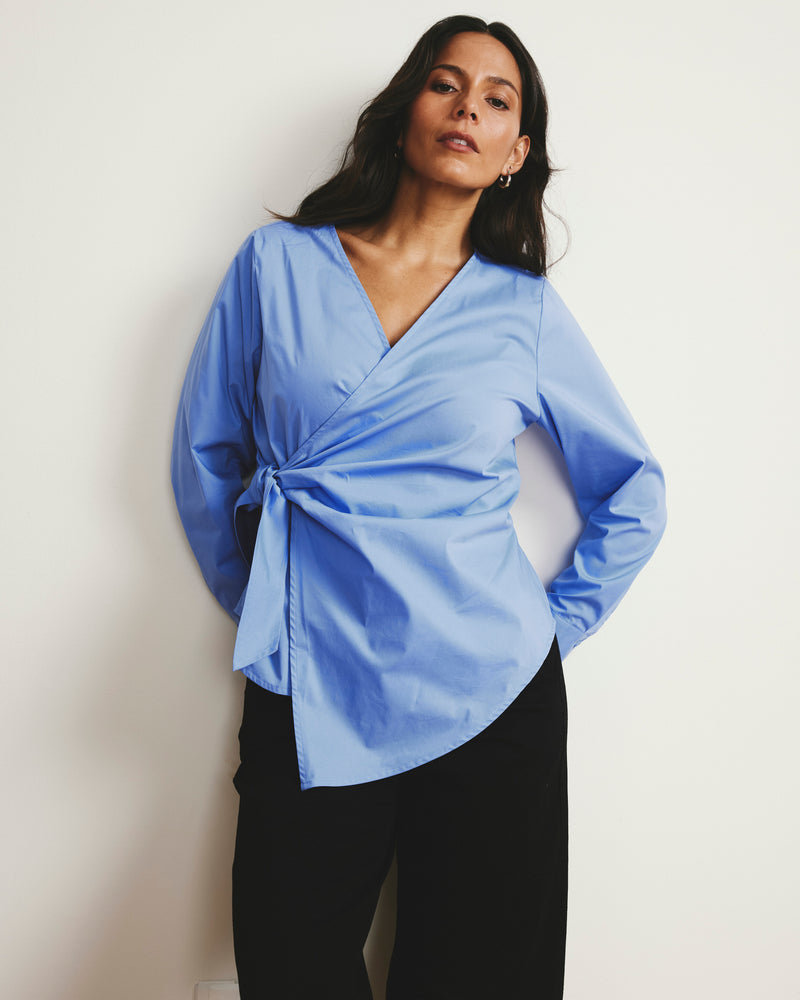 Woman wearing Beacon Stretch Poplin Wrap Shirt - Soft Blue from Universal Standard