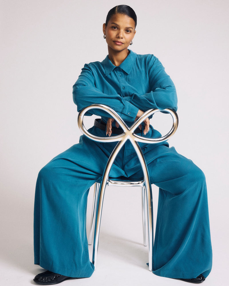 Woman wearing Palais Cooling Cupro Wide Leg Pant - Blue Beetle from Universal Standard