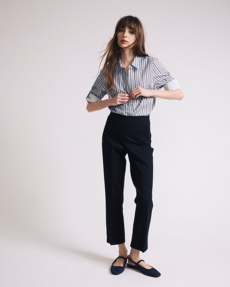 Woman wearing Button Back Poplin Polo Shirt - Smokey Blue Stripe from Universal Standard