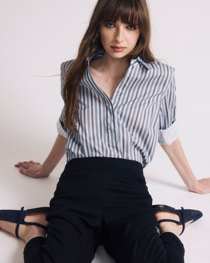 Woman wearing Button Back Poplin Polo Shirt - Smokey Blue Stripe from Universal Standard