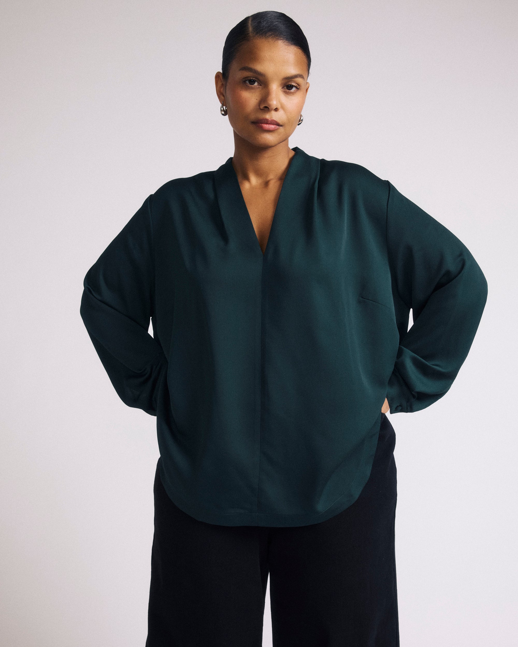 Woman wearing Georgette Satin Cambria Blouse - Forest Green from Universal Standard