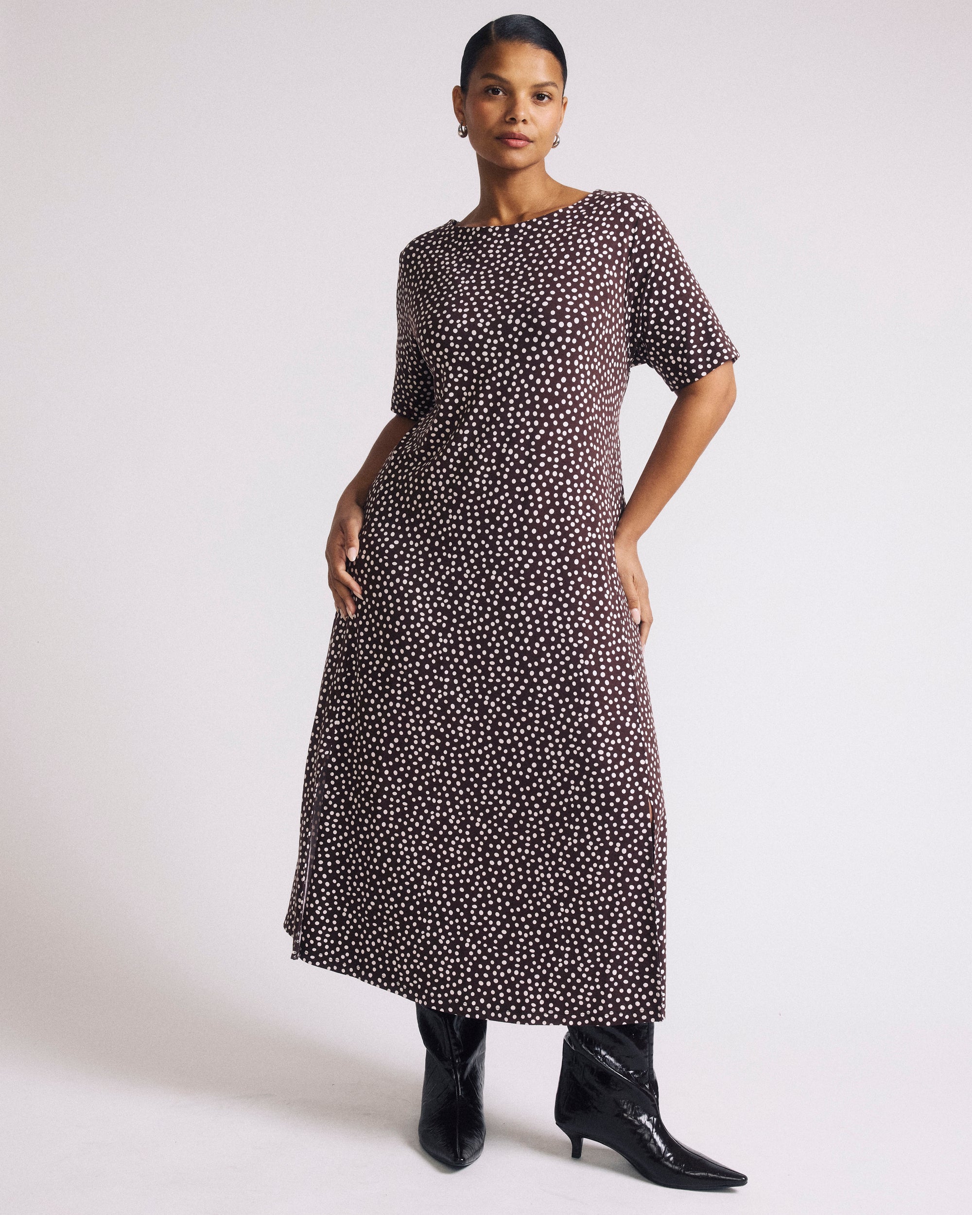 Woman wearing Serena Boat Neck Divine Jersey Dress - Brown/White Dot Print from Universal Standard