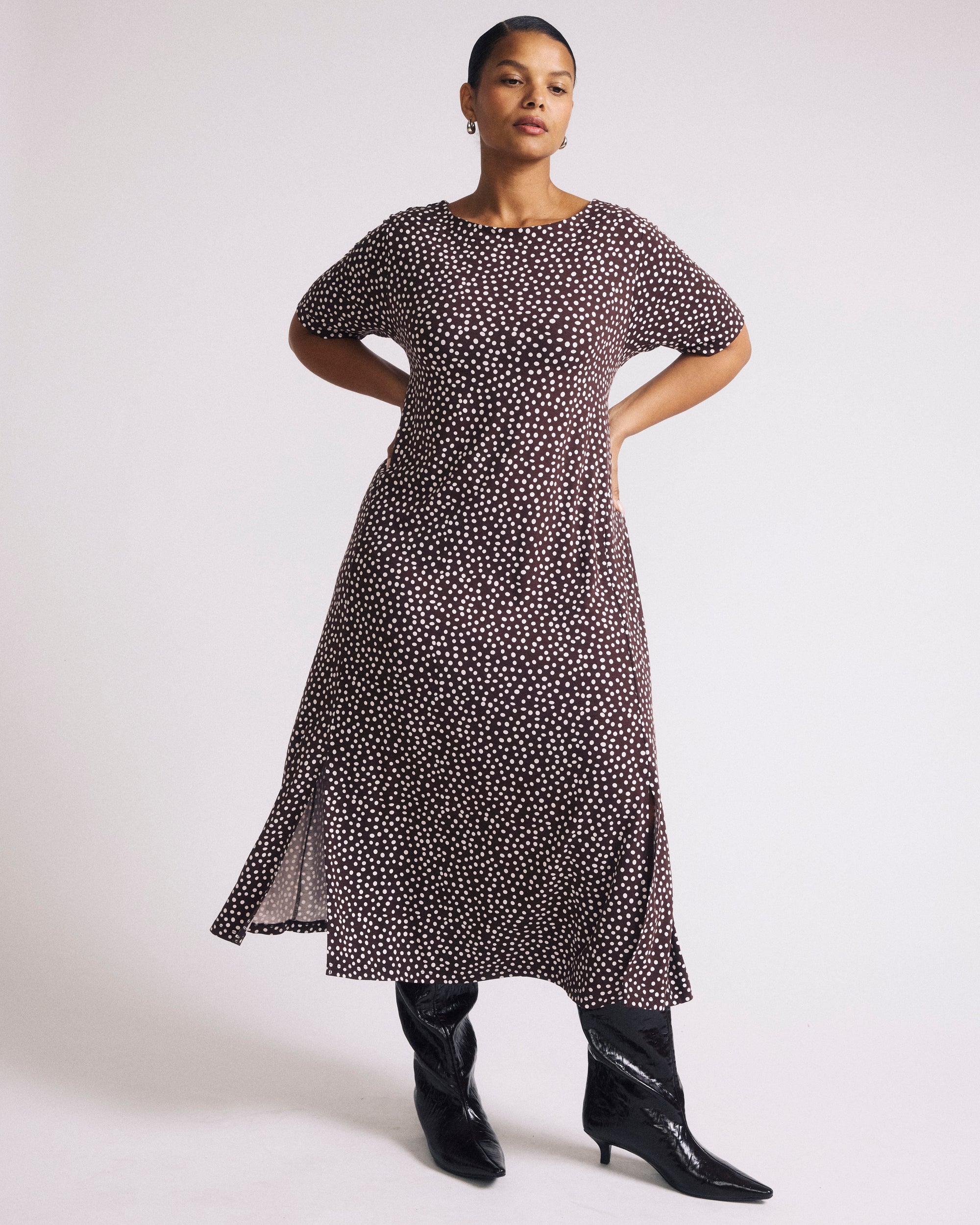 Woman wearing Serena Boat Neck Divine Jersey Dress - Brown/White Dot Print from Universal Standard