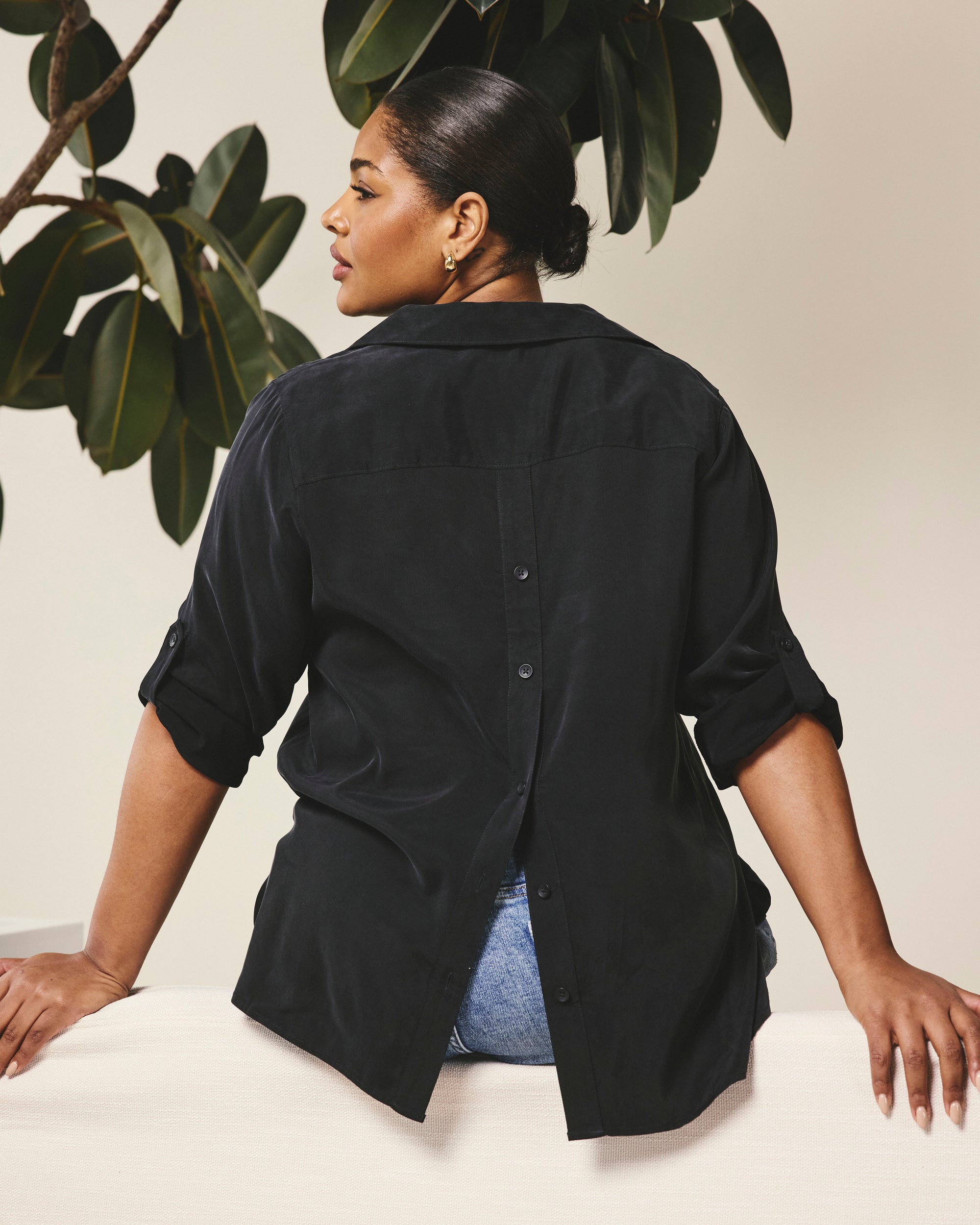 Woman wearing Button Back Stretch Cupro Polo Shirt - Black from Universal Standard