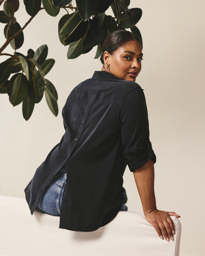 Woman wearing Button Back Stretch Cupro Polo Shirt - Black from Universal Standard