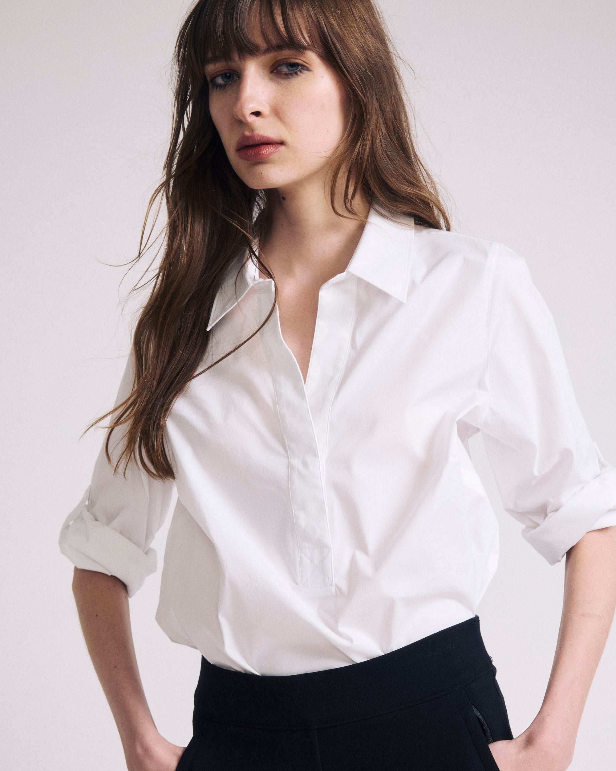 Woman wearing Button Back Poplin Polo Shirt - White from Universal Standard