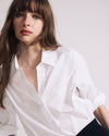 Woman wearing Button Back Poplin Polo Shirt - White from Universal Standard