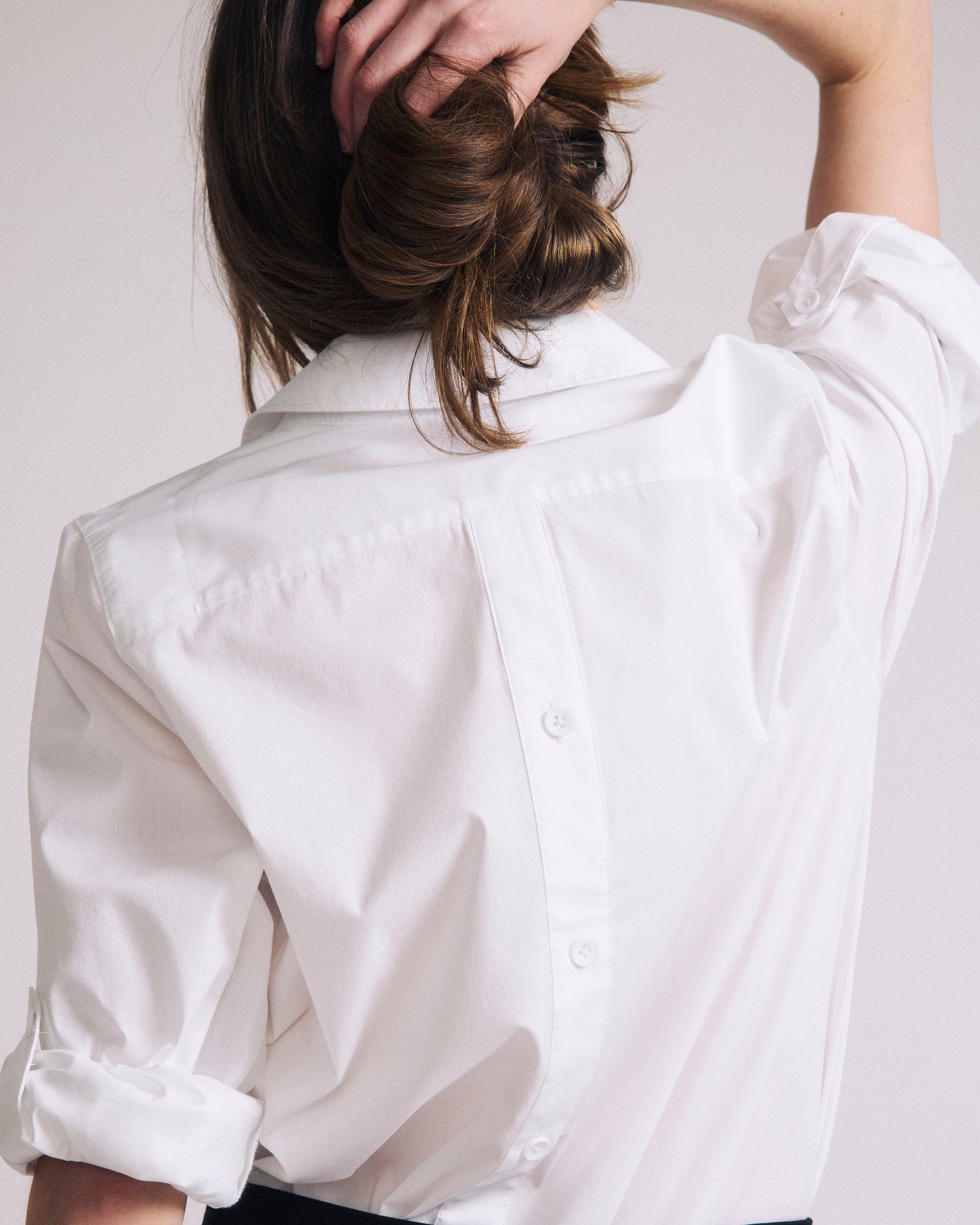 Woman wearing Button Back Poplin Polo Shirt - White from Universal Standard