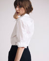 Woman wearing Button Back Poplin Polo Shirt - White from Universal Standard