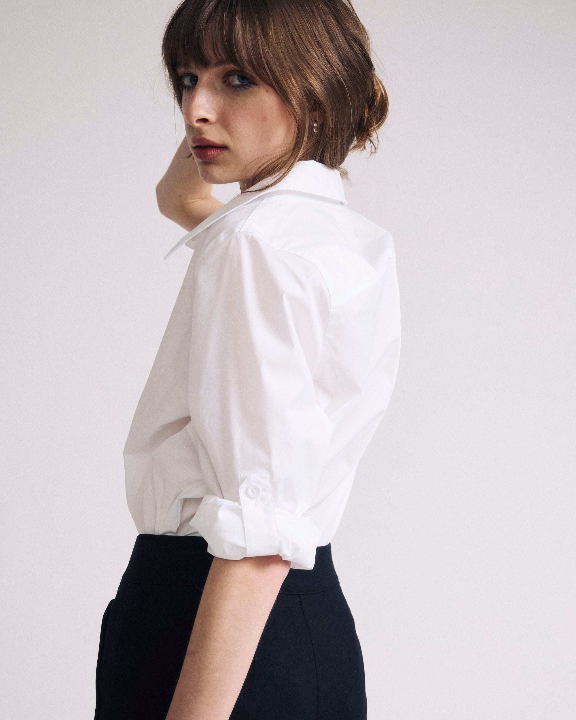 Woman wearing Button Back Poplin Polo Shirt - White from Universal Standard