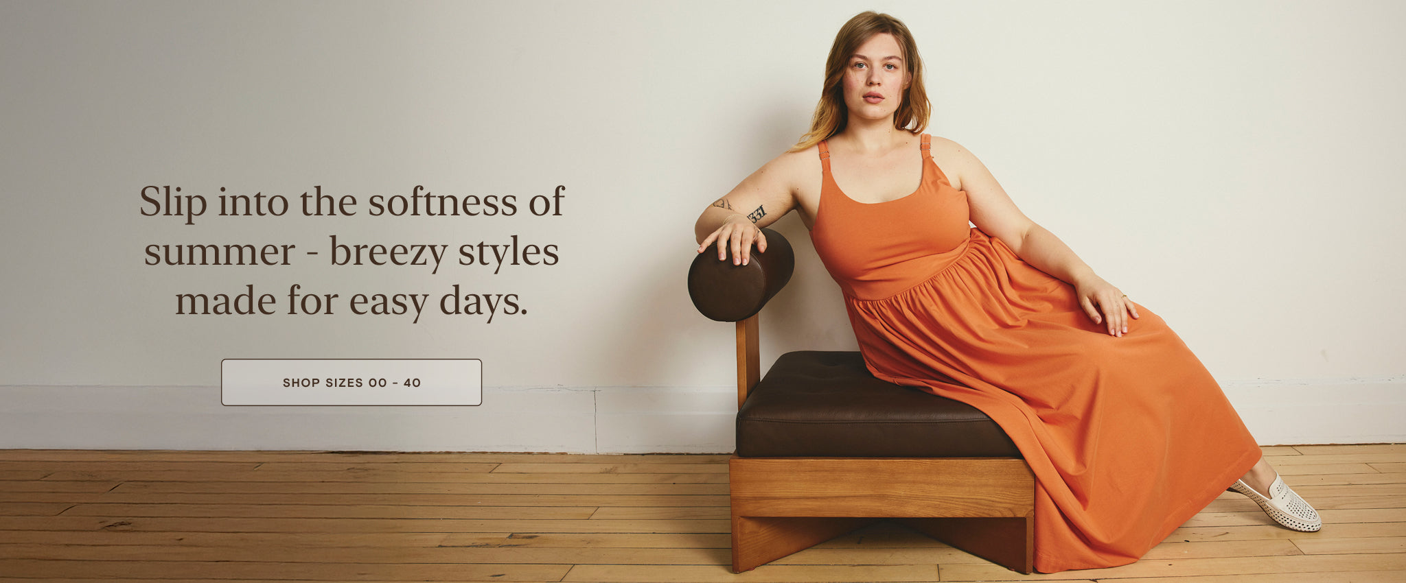 model wearing an orange dress with text that reads slip into the softness of summer with shop now link that links to effortless summer styles collection