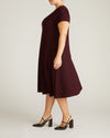 Woman wearing Lucinda Ponte Dress - Black Cherry from Universal Standard
