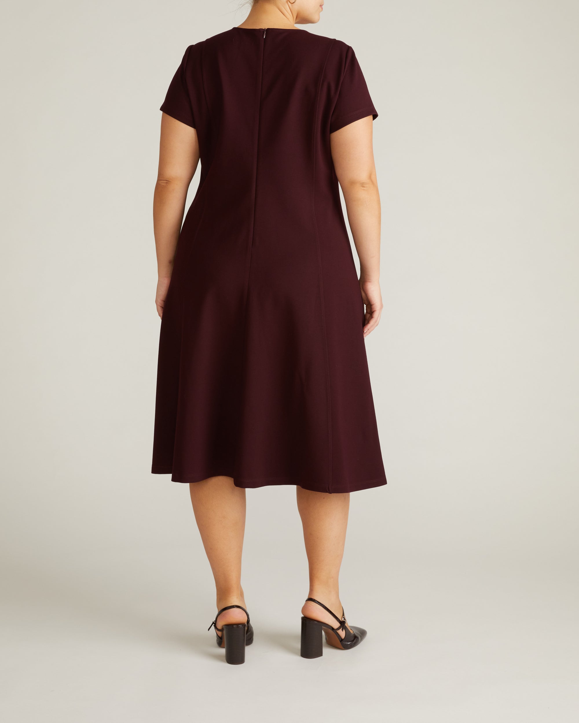 Woman wearing Lucinda Ponte Dress - Black Cherry from Universal Standard
