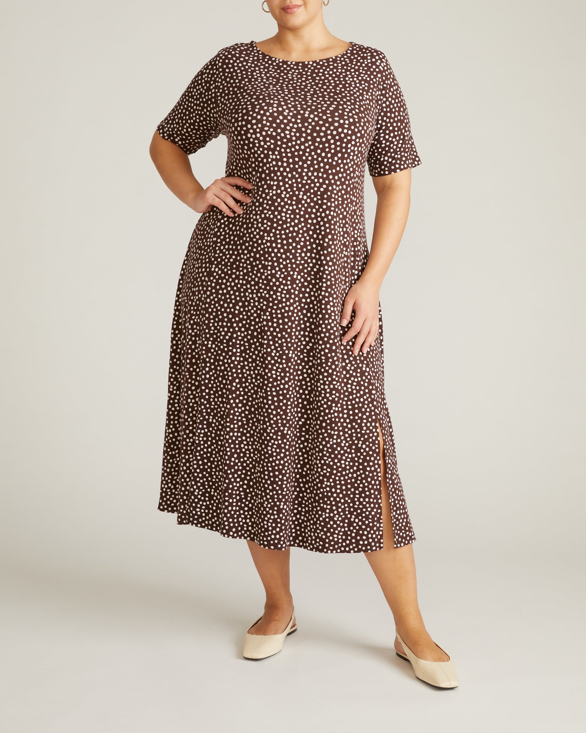 Woman wearing Serena Boat Neck Divine Jersey Dress - Brown/White Dot Print from Universal Standard