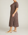 Woman wearing Serena Boat Neck Divine Jersey Dress - Brown/White Dot Print from Universal Standard