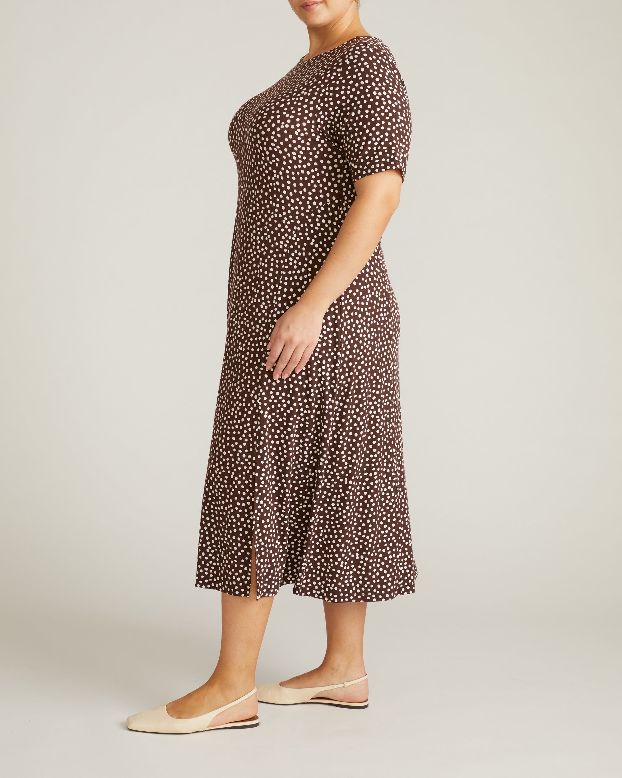Woman wearing Serena Boat Neck Divine Jersey Dress - Brown/White Dot Print from Universal Standard