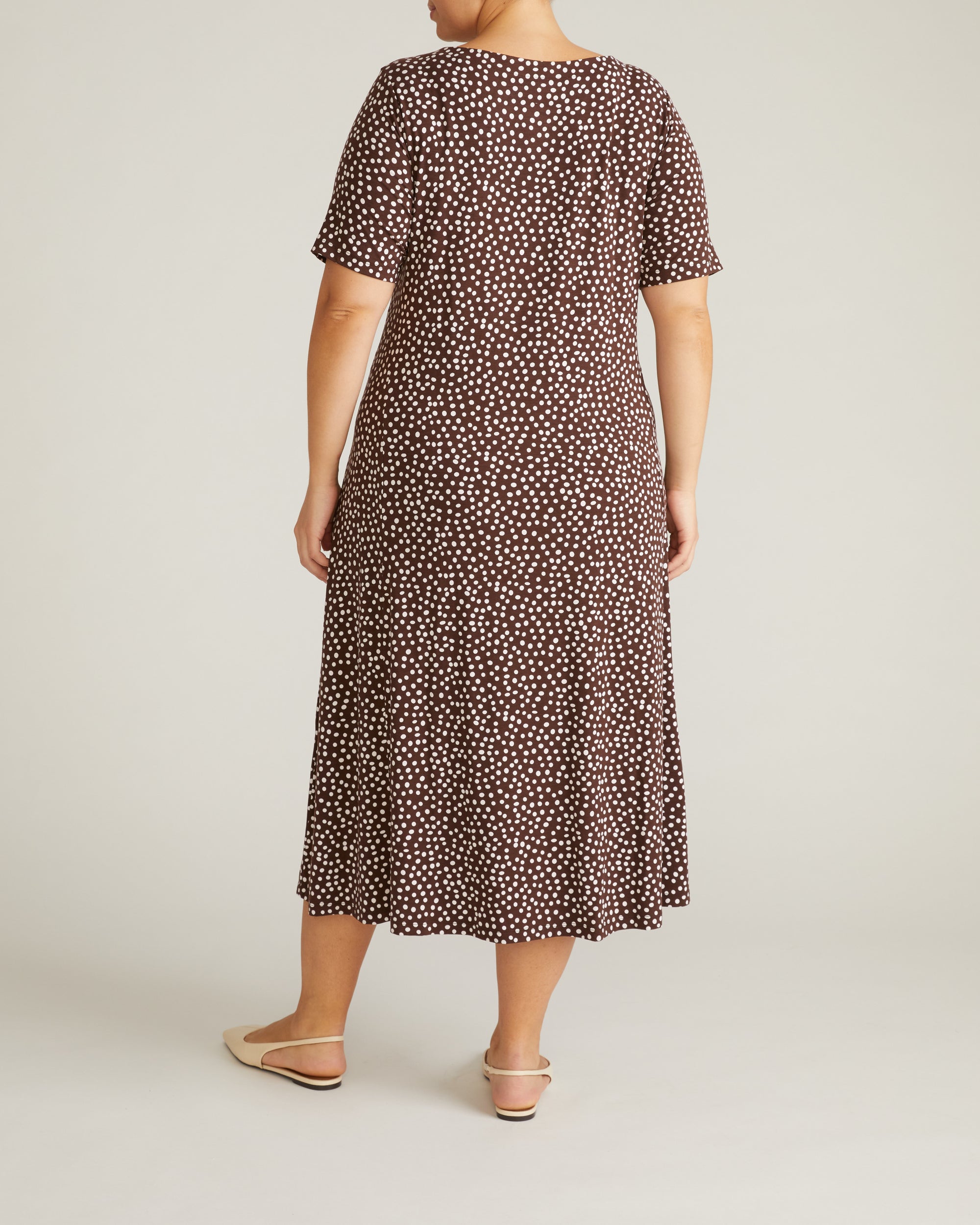 Woman wearing Serena Boat Neck Divine Jersey Dress - Brown/White Dot Print from Universal Standard