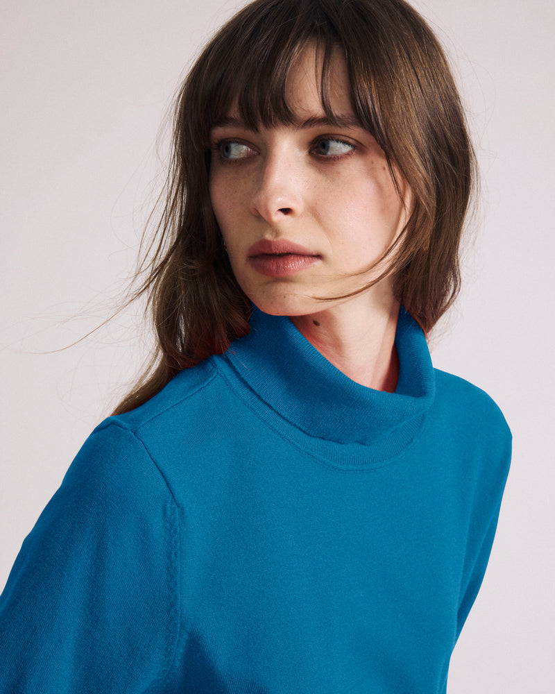 Woman wearing Savvy Fine Knit Turtleneck Sweater Top - Blue Beetle from Universal Standard