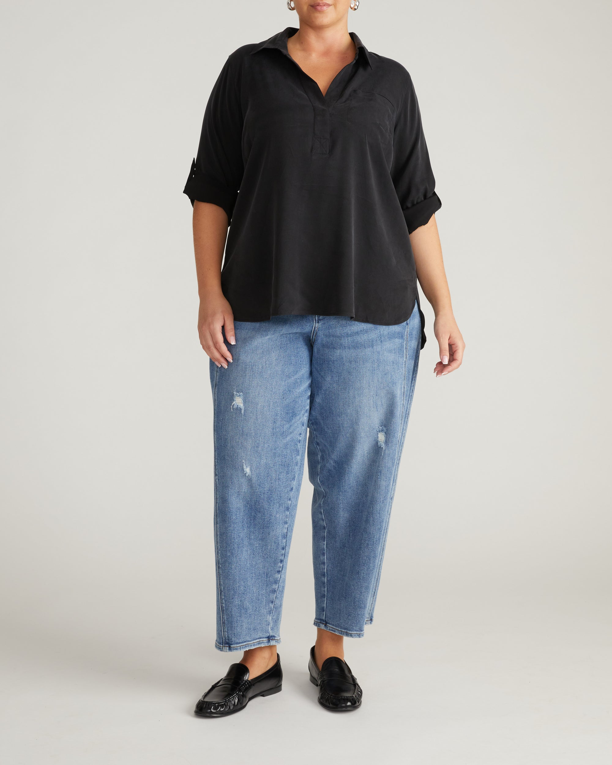 Woman wearing Button Back Stretch Cupro Polo Shirt - Black from Universal Standard