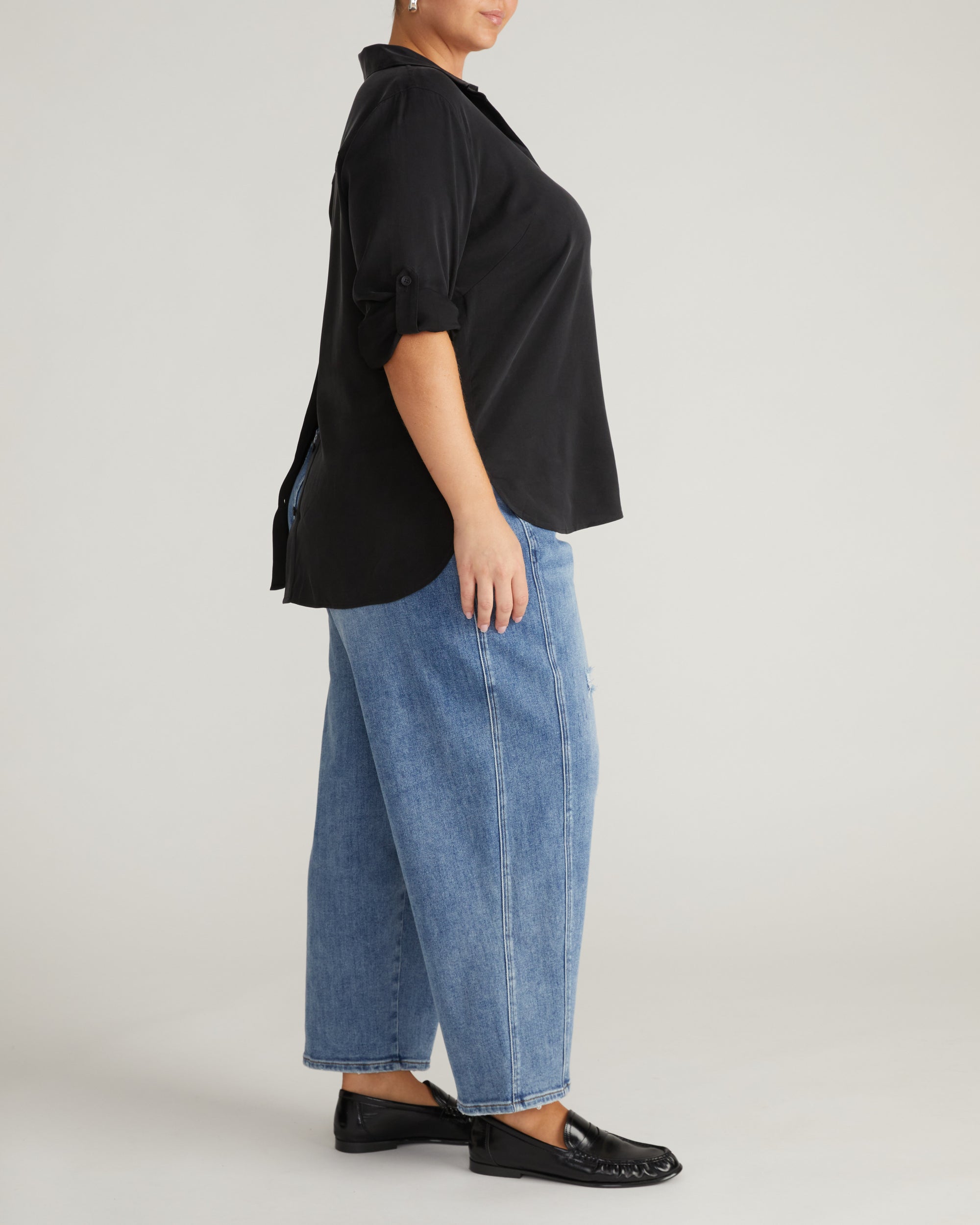 Woman wearing Button Back Stretch Cupro Polo Shirt - Black from Universal Standard