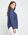 Woman wearing Minimalist Stretch Cotton Chambray Shirt - Dark Indigo from Universal Standard